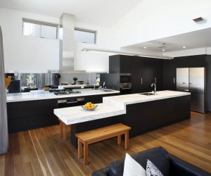 a modern kitchen with a large island and wooden flooring