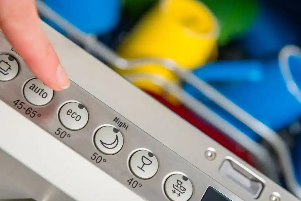 Close-up picture of hand setting eco-friendly kitchen appliances. Eco-friendly kitchen designs in Strathfield, Australia.